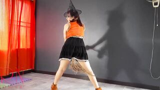 HALLOWEEN 2021 Witch inside a beauty red suit. Red-haired witch with pumpkins and a broom. Regina Noir