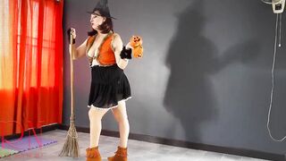 HALLOWEEN 2021 Witch inside a beauty red suit. Red-haired witch with pumpkins and a broom. Regina Noir