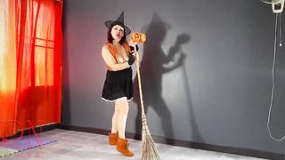 HALLOWEEN 2021 Witch inside a beauty red suit. Red-haired witch with pumpkins and a broom. Regina Noir