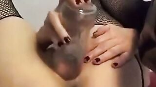 Mature Cam Girl Sucks Bottle on Webcam in Fishnet Lingerie