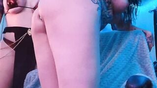 Tattooed Shemale Bent Over While Blonde Babe Pushes Metal Plug in Ass