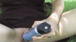 Young red haired with huge breasts dildoing her twat outside