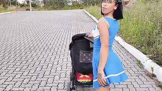 Delightful mother inside blue dress without underwear during street walk.