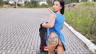 Delightful mother inside blue dress without underwear during street walk.
