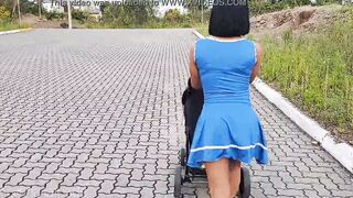 Delightful mother inside blue dress without underwear during street walk.