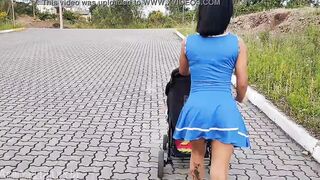 Delightful mother inside blue dress without underwear during street walk.