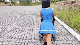 Delightful mother inside blue dress without underwear during street walk.