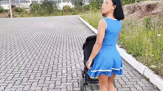Delightful mother inside blue dress without underwear during street walk.