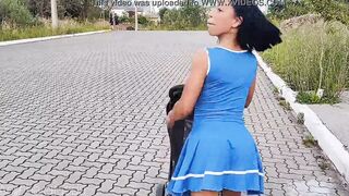 Delightful mother inside blue dress without underwear during street walk.