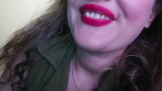 ADORABLE WOMAN PAINTS HER LIPS RED AND SMOKES a CIGARETTE