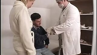 Guys clothed as doctors put long sex toy on male patient