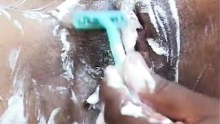 African stud shaves bushy twat of inked african ho