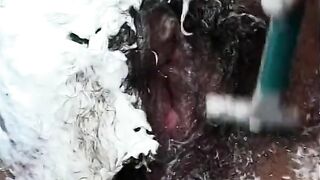 African stud shaves bushy twat of inked african ho